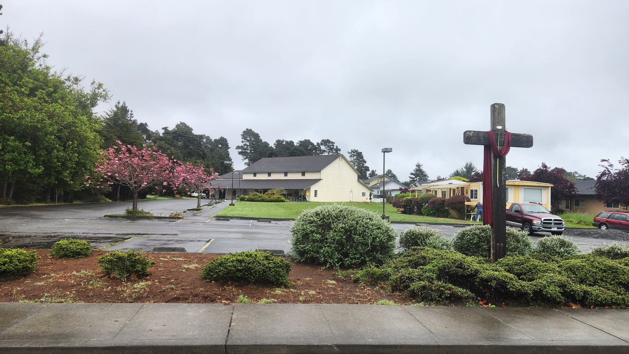 Church property from the street with cross and cherry blossoms